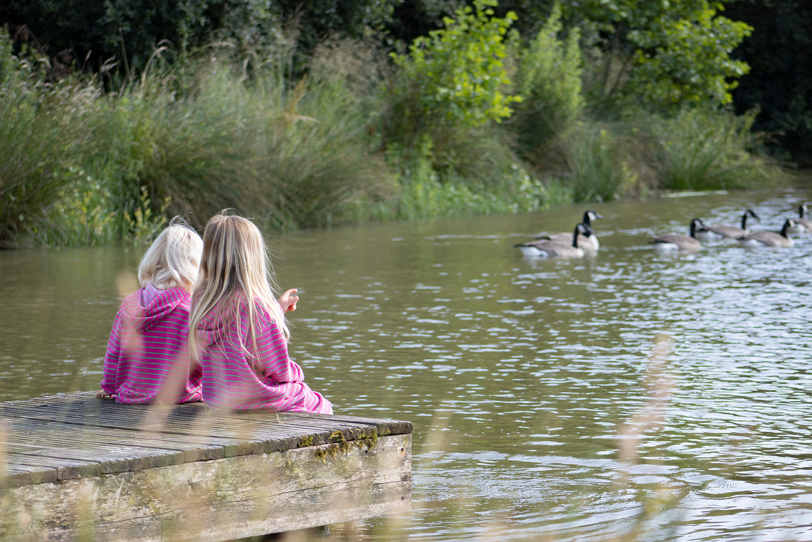 Sisters in Fuchsia watching the wildlife from a Jetty